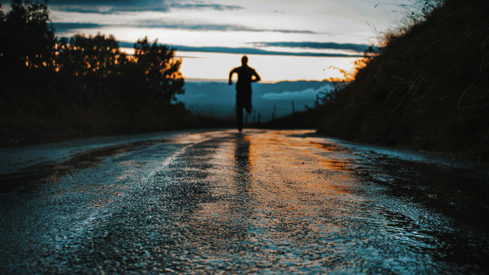 A runner on a quiet road at sunrise